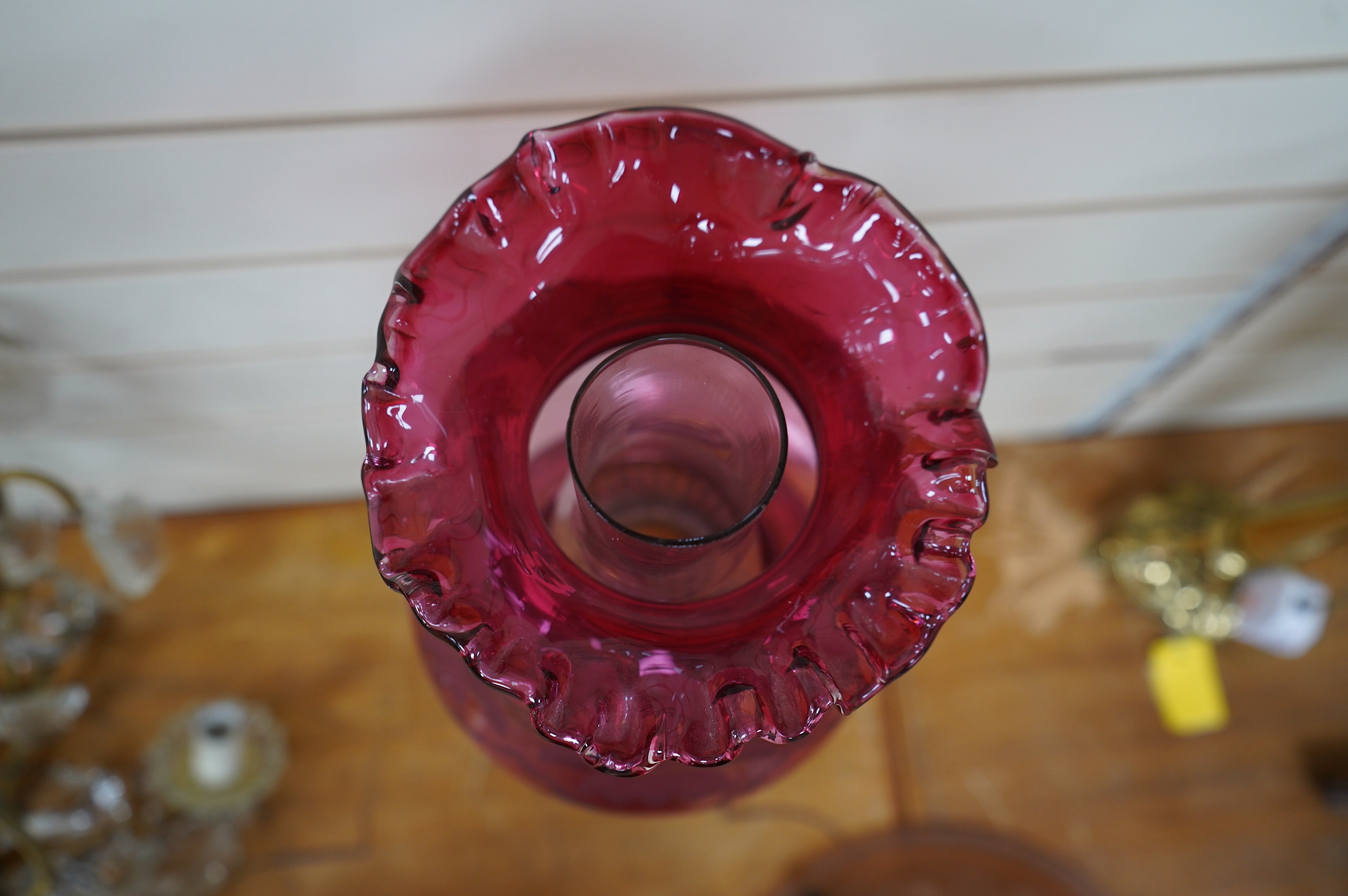 A Victorian oil lamp on brass base with cranberry font, acid etched cranberry shade chimney, overall 62cm high. Condition - good